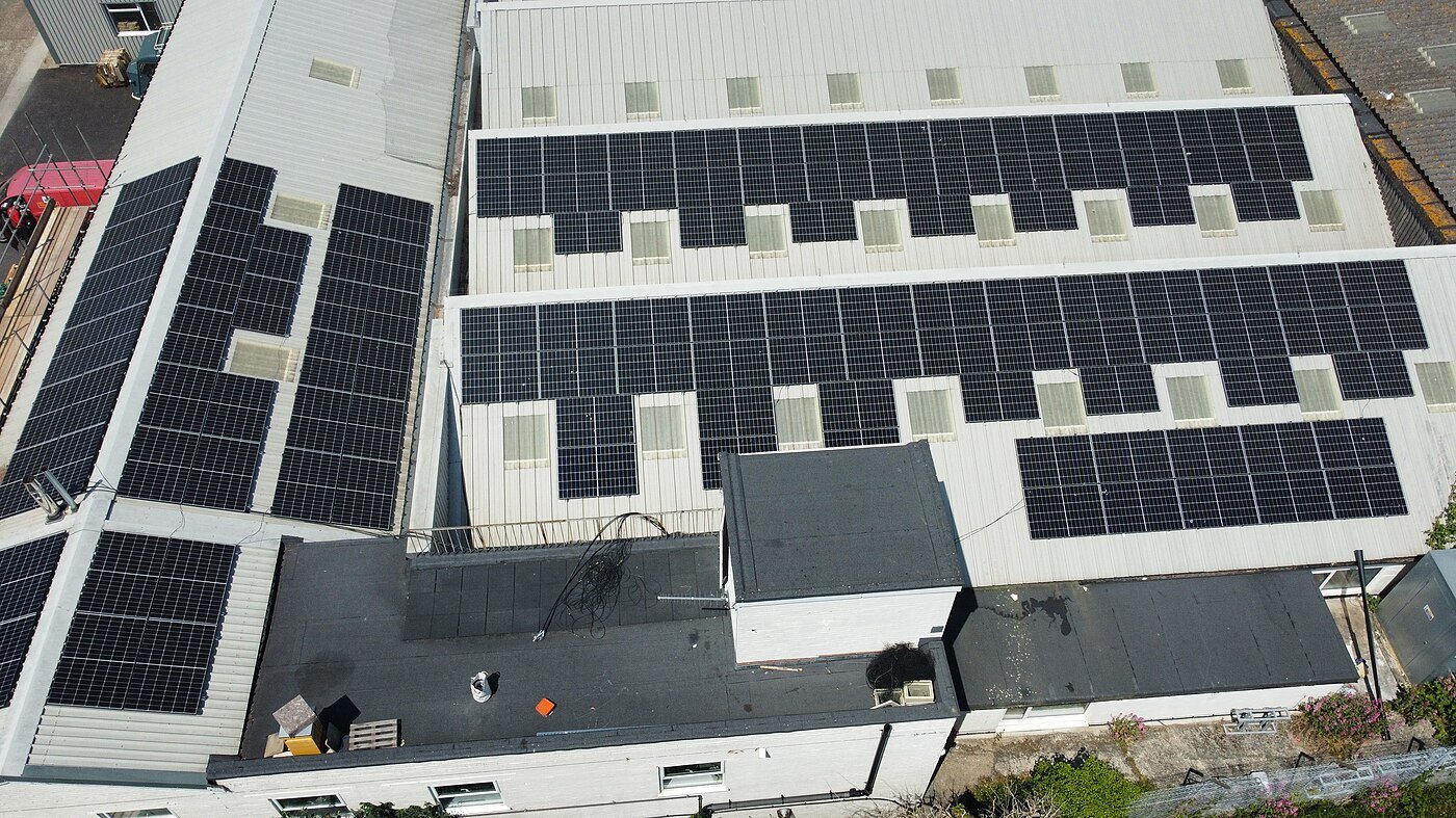 Aerial view of a large solar panel array generating electricity from sunlight.